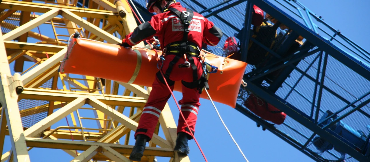 iemand wordt gered met brancard op hoogte